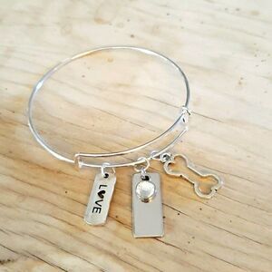 Bracelets by Sandra silver tone adjustable, dog bone